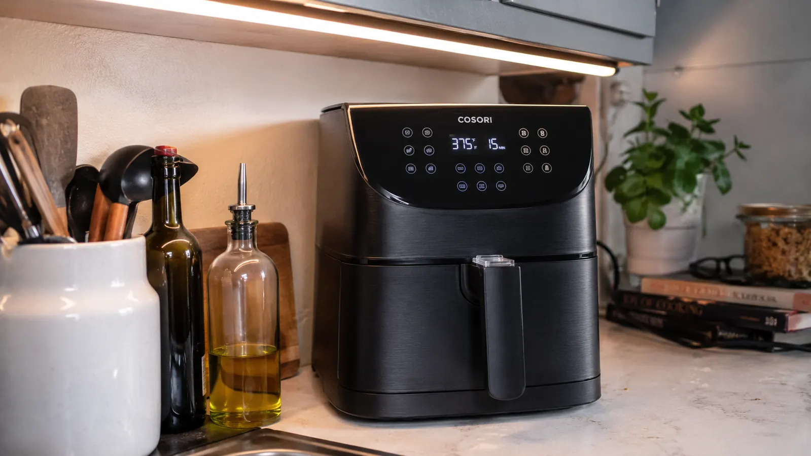 Close-up of the air fryer sitting under an upper cabinet with visible clearance on all sides